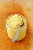 Saffron mayonnaise in a jar with a spoon