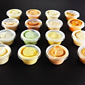 Various dips in small plastic bowls
