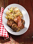 Meat balls with mushrooms, bacon and potato salad