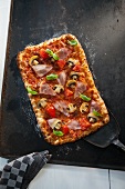 Ham, mushroom and tomato tray bake pizza (seen from above)