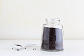 Black mustard seeds in a jar and on a spoon