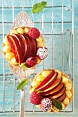 Fruit tartlets with raspberries, cherries and peaches
