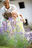 woman and little girls in a garden