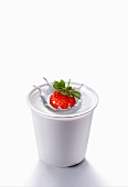 Splash created by a strawberry falling into yogurt
