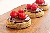 Shortbread Cookies with Chocolate Hazelnut Spread and Raspberries; On Cutting Board