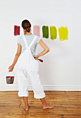 Woman looking at colour swatches on wall