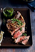 Partially Sliced Grilled Rib-Eye Steak with Herb Sauce