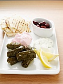 Starter plate with dolmades, tzatziki, tarama, olives and bread