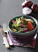 A salad with roasted red onions, grapefruit and rocket