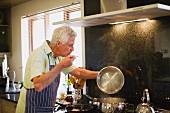 Older man cooking in kitchen