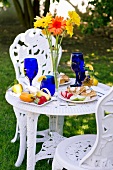 Outdoor Table Set with a Belgian Waffle Breakfast; Tall Flowers in a Vase on Table