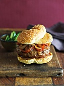 Hamburger with Grilled Onions and Peppers on a Sesame Seed Bun