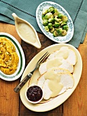 Thanksgiving Dishes; Sliced Turkey with Gravy, Brussels Sprouts, Mashed Sweet Potatoes and Cranberry Sauce