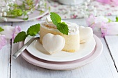 Slice of cream cake with macaron hearts