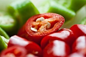 Red and green chilli peppers, sliced (close-up)