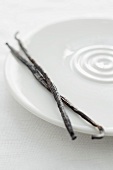 Two vanilla pods on a plate