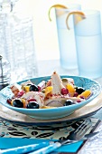 Chicken salad with orange fillets, black olives and dried cranberries