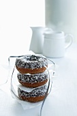 Doughnuts with flaked coconut, stacked and tied together
