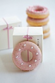 Doughnuts with pink and white sugar icing as a gift