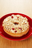 A doughnut topped with oats and cranberries
