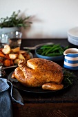 Roast chicken with roast potatoes and beans