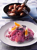 Heringsstipp (creamy herring salad) with eggs, apples and onions