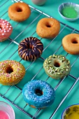 Doughnuts with colourful glaze on a wire rack