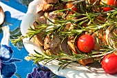 Pork chops with rosemary and cherry tomatoes on a serving platter