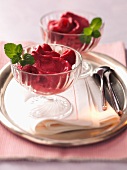 Raspberry ice cream in a glass bowl
