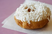A Vanilla Frosted Doughnut with Shredded Coconut