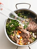 Ingredients for light veal stock in a pot