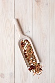 Various beans and lentils on a wooden scoop