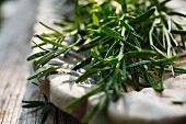 Fresh rosemary in a wooden bowl (close-up)