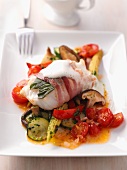 Cod saltimbocca on a bed of ratatouille