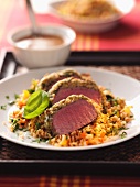 Saddle of lamb with a crust on a bed of barley salad