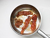 Bacon being fried