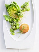 Fava beans with cos lettuce and a bread roll