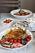 Duck with roast potatoes, mushrooms and cherry tomatoes