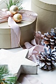 Decorated Christmas gift box, pinecones and star-shaped ornament