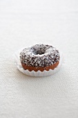 A doughnut with chocolate glaze and grated coconut
