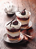 Layered desserts made with cake, cream and cherries
