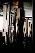 Dark store room with wooden boards leaning on wall