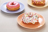 Doughnuts with colourful glaze and sugar sprinkles