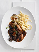 Wild boar goulash with shallots and spätzle (soft egg noodles from Swabia)