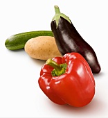A pepper, an aubergine, a potato and an courgette