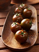 Black Zebra tomatoes in a wooden dish