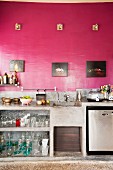 Elevation view of concrete kitchen counter with deep pink wall