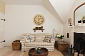 Sitting room with a white and beige gingam sofa (Ektorp from Ikea) wooden Afghan coffee table and a large Cafe de Marguerites wall clock