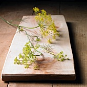 Dill flowers on a wooden board