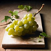 Green grapes on a wooden board